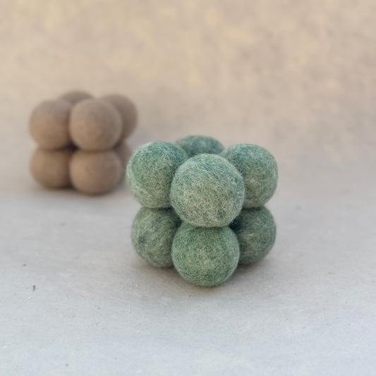 Wool felt cat puzzle toy made from small felt balls designed for cat enrichment and interactive play.