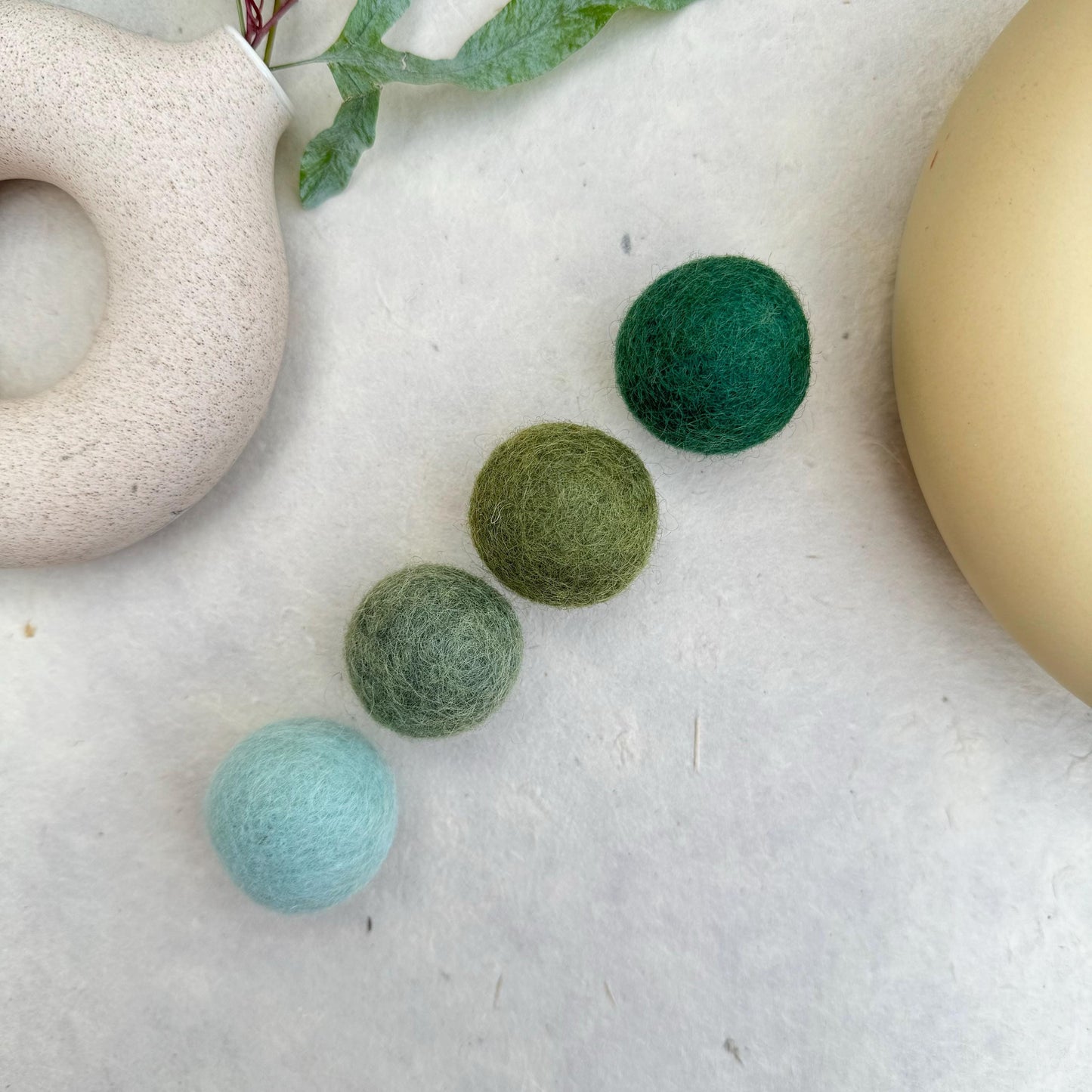 Close-up of handmade wool felt catnip toy balls - soft, durable, and fully natural cat toy