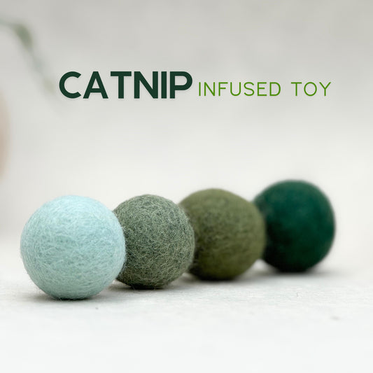 Minimal wool felt cat toy set - four handmade catnip-infused felt balls in tin, natural design for modern homes.